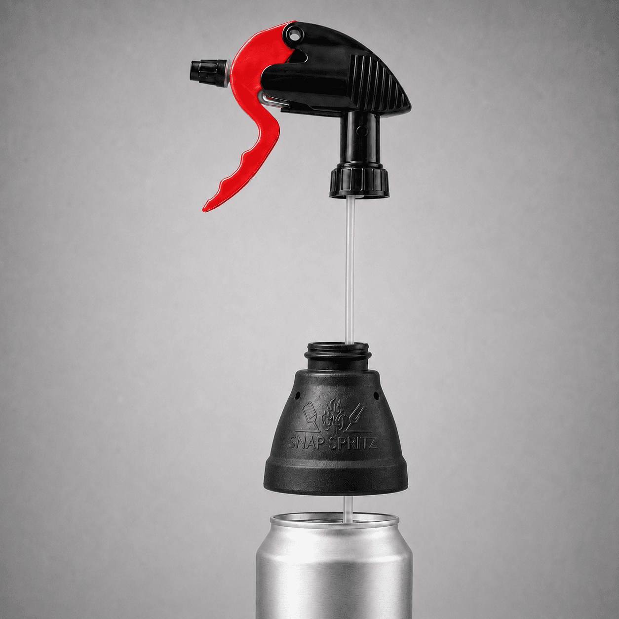 Snap Spritz separated into its spray head, flexible intake tube, and universal can cone, above a standard aluminium can